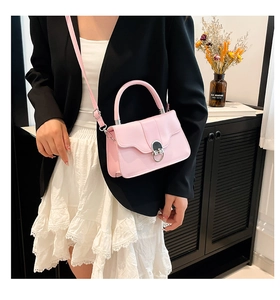 Close-up of the adjustable strap and silver metal buckle on this pink crossbody bag