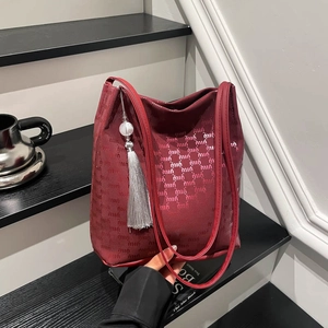 Burgundy hobo tote bag with logo pattern and decorative silver fringe tassel pendant