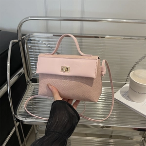 Pink PU leather tote bag with houndstooth texture and golden twist lock closure
