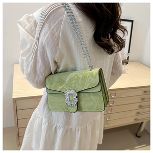 Detail of light green marble patterned crossbody bag with shiny rhinestone square buckle