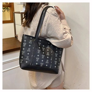 Detail of black tote bag featuring grey bear patterns and durable reinforced bottom