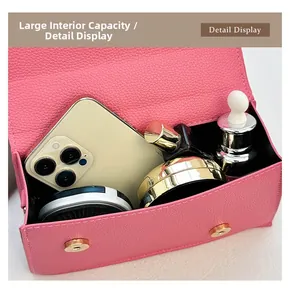 Detail view of pink lychee leather handbag showing spacious interior for essentials