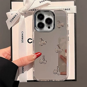 Close-up of mirror phone case with silver rhinestone cherries and pearl wrist strap