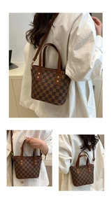 Detail view of brown checkerboard pattern mini tote bag with adjustable shoulder strap