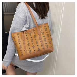 Brown monogram tote bag detail showing large capacity and lychee texture faux leather material