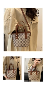 Detail view of the vintage checkerboard tote bag featuring brown trim and adjustable strap