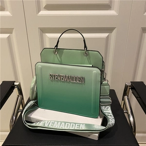 Green gradient crossbody bag with Steve Madden logo and wide woven shoulder strap
