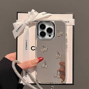 Macro view of mirror finish iPhone case with rhinestone cherry charms and clear edges