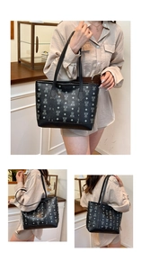 Detail of black pebbled leather tote bag featuring silver bear and diamond pattern prints