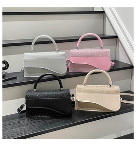 Detailed view of four sequined crossbody bags in silver, pink, black, and beige colors
