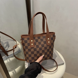 Elegant brown checkerboard pattern tote bag with gold studs and adjustable shoulder strap