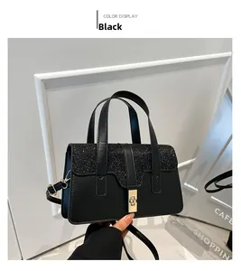 Detail of elegant black sequin handbag featuring a gold metallic twist lock and handle