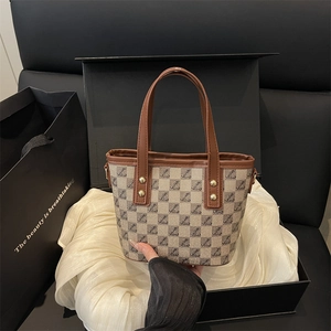 Chic retro checkerboard bucket bag with brown leather straps in a luxury gift box