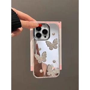 Mirror finish iPhone case with 3D crystal butterflies and pearl accents on gray background