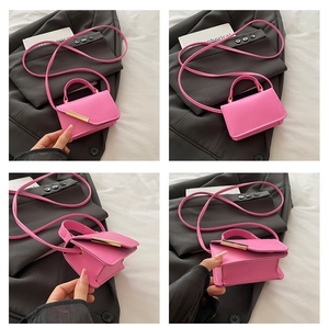 Detail view of mini rose pink crossbody bag showing texture and golden magnetic hardware
