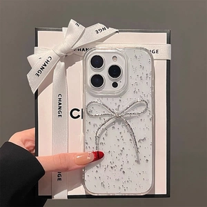 Detailed view of clear iPhone case with silver glitter and a metallic 3D ribbon bow