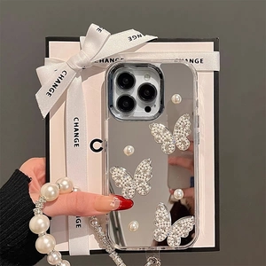 Close-up of mirror phone case with 3D pearl butterflies and a long pearl wrist strap