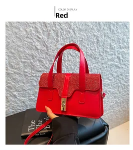 Detail of red luxury handbag with sparkling diamond texture and gold twist lock closure