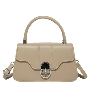 Chic beige underarm bag with silver hardware clasp and curved handle on white background