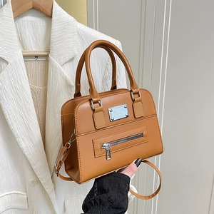 Brown leather Boston bag with top handles and adjustable shoulder strap for women