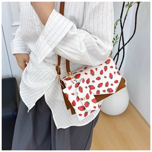 Chic strawberry print crossbody bag set with small wallet accessory on model