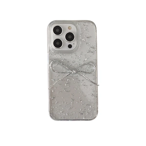 Transparent iPhone case with silver glitter sequins and 3D bow decoration on white background
