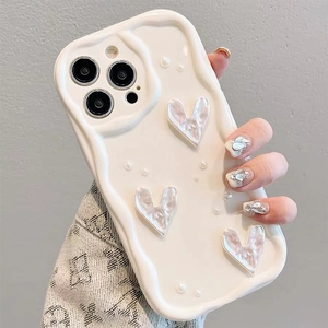 Chic iPhone case with cream wavy edges and pearlescent 3D hearts and pearl accents