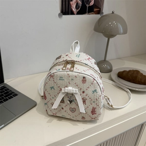 Mini sac à dos crème avec motifs dessins animés et nœud dans un décor de bureau
