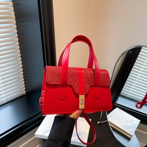 Red sequined luxury handbag with gold twist lock and adjustable shoulder strap