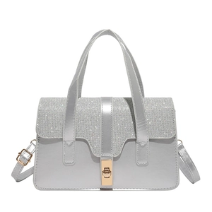 Silver rhinestone flap handbag with gold metal clasp and adjustable shoulder strap