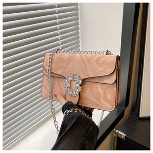 Detail of light pink marble pattern handbag with a crystal buckle and silver chain