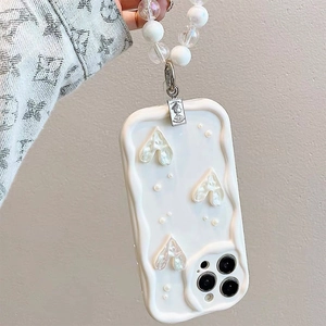 Detail of white wavy iPhone case with pearlescent hearts, pearls and beaded wrist strap