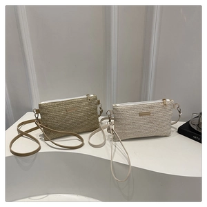 Detailed view of woven crossbody bag texture with premium zipper and metallic logo accent