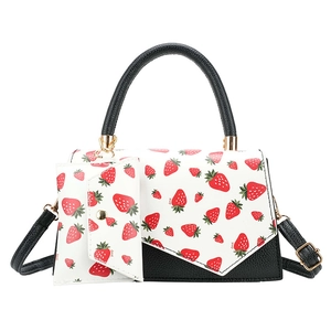 Women's black and white strawberry print tote set with matching mini pouch and strap