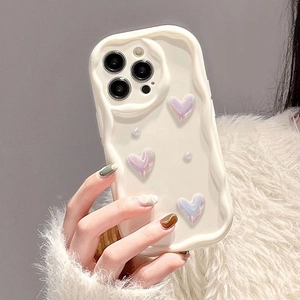 Detail of cream wave-edge iPhone case featuring pearlescent purple hearts and a pearl strap