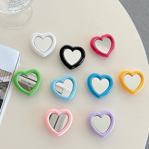 Collage of colorful heart-shaped expanding phone grips and mini mirrors for mobile devices