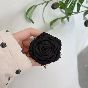 Detail of the multi-layered black fabric rose phone socket with vintage frayed edges