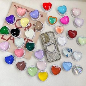 Colorful magnetic heart-shaped retractable phone sockets in various vibrant glossy finishes