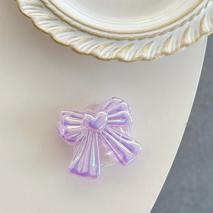 Detailed macro view of an iridescent purple bow-shaped phone socket grip