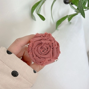Detail of 3D fabric rose phone socket with vintage dusty pink petals and fringe edges