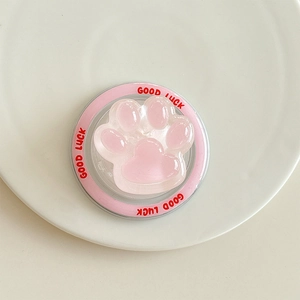 Gros plan du support de téléphone patte de chat rose avec texture gelée sur plateau céramique