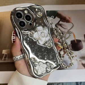 Close-up of silver electroplated iPhone case with 3D camellia flower and beaded wrist strap
