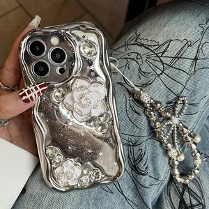 Detail of silver wavy iPhone case with 3D white roses and beaded metal lanyard strap
