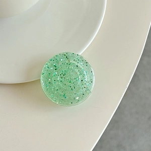 Close-up of a round mint green glitter phone socket with sparkling sequins inside