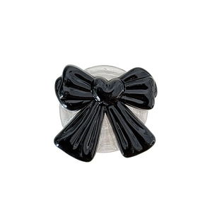 Minimalist black heart bow phone grip with clear glittery retractable base holder
