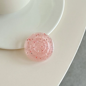 Detail of pink glitter phone socket featuring sparkling sequins and acrylic finish