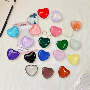 Supporti per telefono a forma di cuore colorati con finitura lucida e vari motivi su tessuto