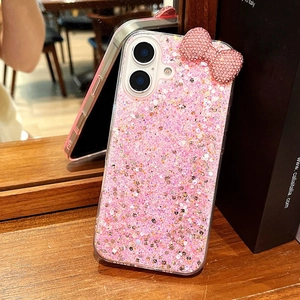 Detailed view of pink glitter phone case with a sparkling rhinestone bow decoration