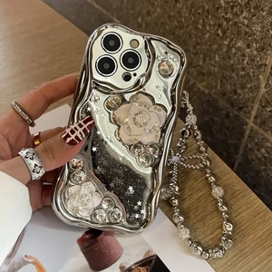 Detail of silver plated iPhone case with 3D camellia, rhinestones and beaded wrist strap