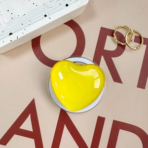 Detail of yellow heart-shaped acrylic phone socket with transparent stand base